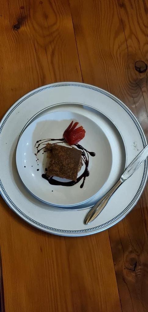 Plated fine dining dessert with chocolate drizzle