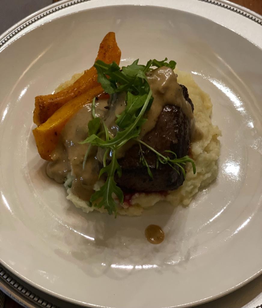 Seared meat with mashed potato, roasted carrot and microgreens