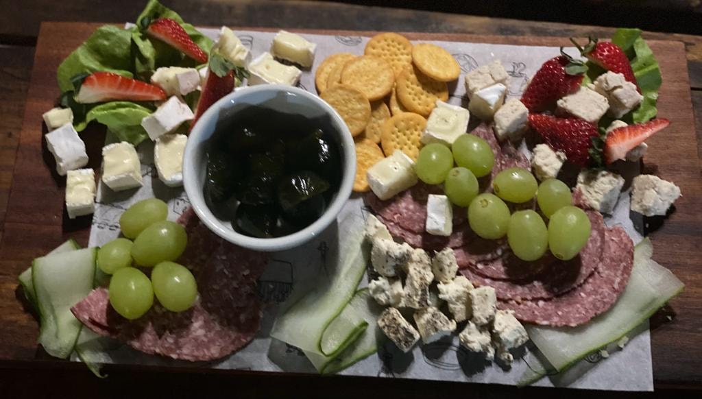 Charcuterie board with cheese, grapes, salami and crackers