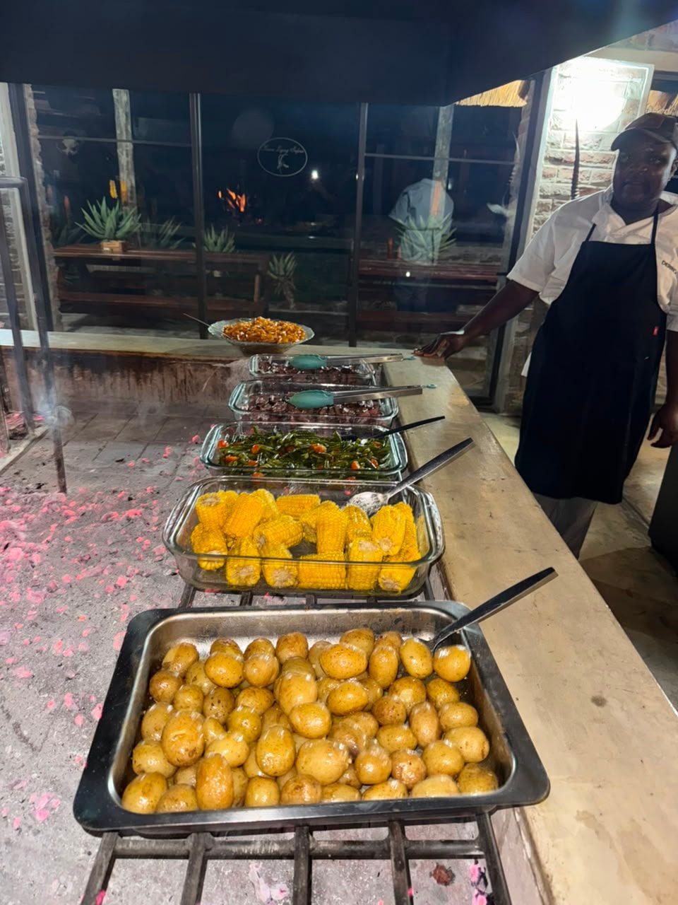 Boma buffet spread with corn, green beans, potatoes and steak trays