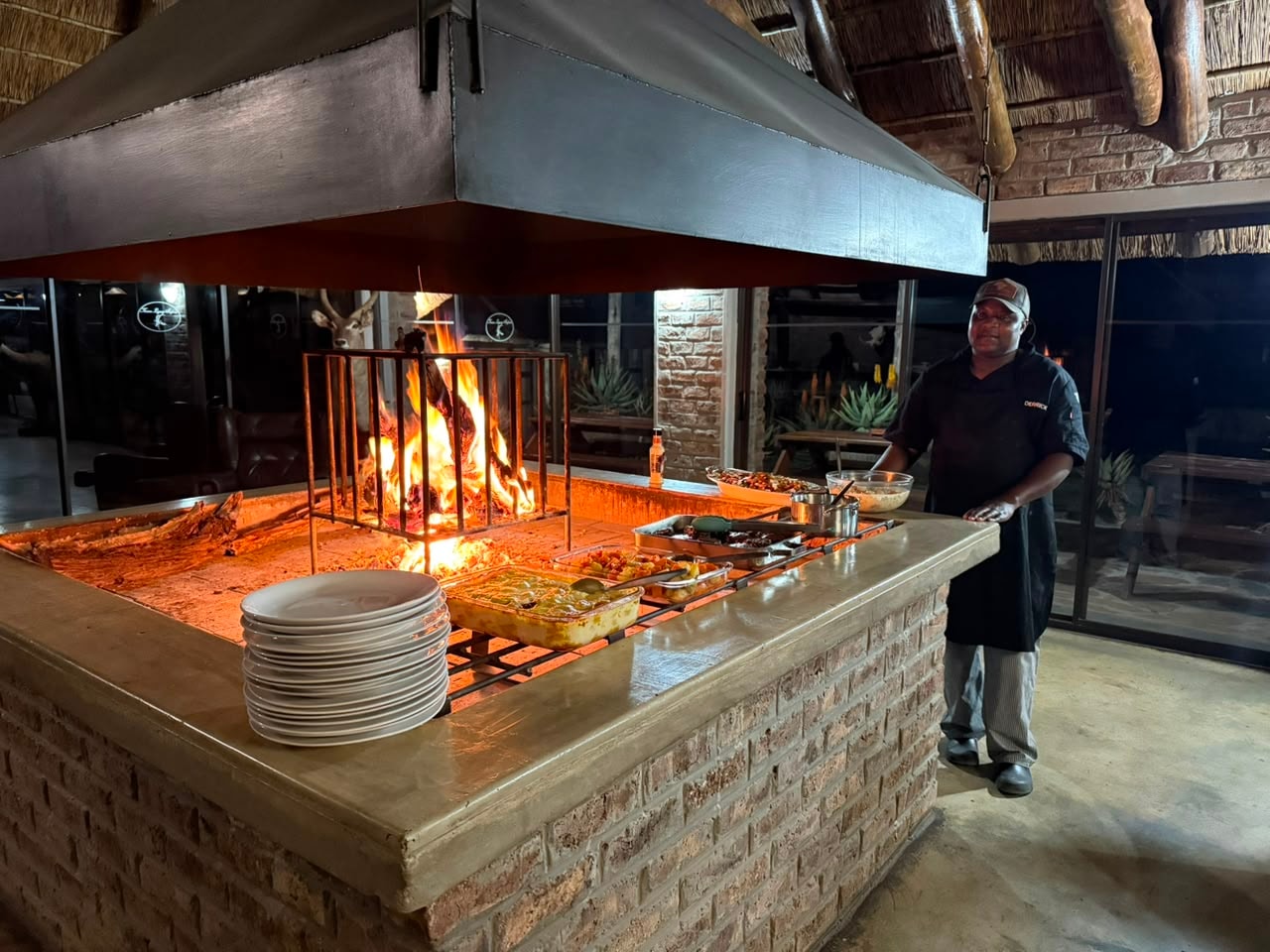 Chef at open fire boma kitchen